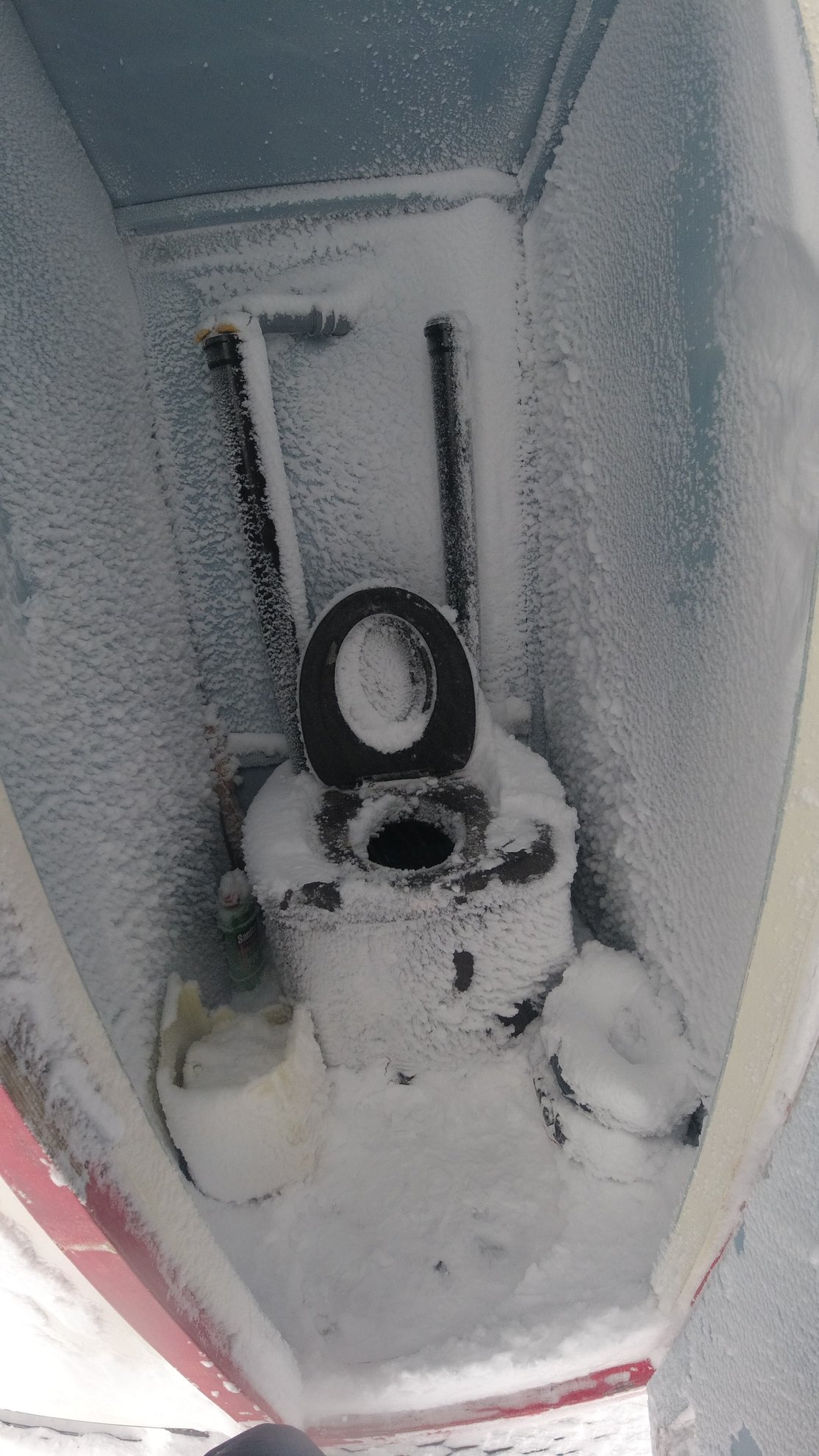 frost covered toilet inside the refuge