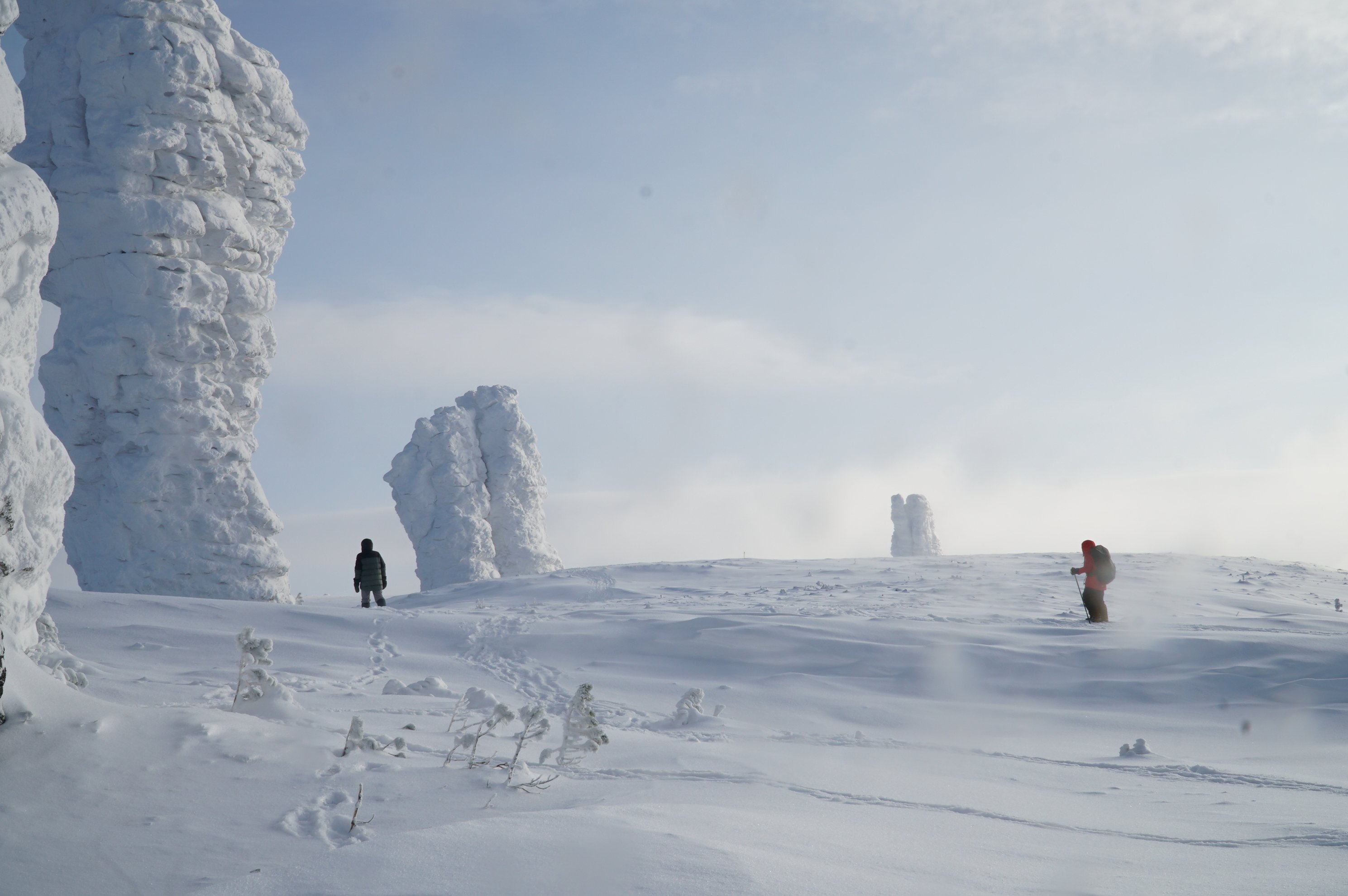 two skiers between snow covered rock pillars