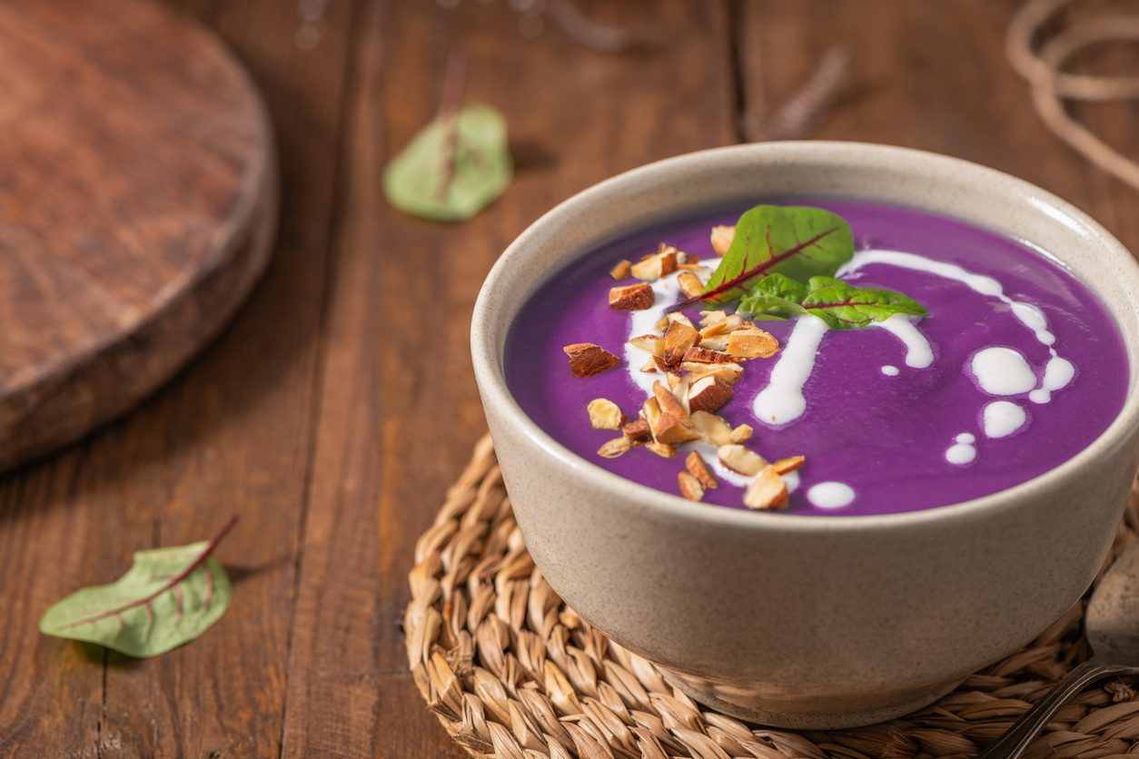 Close-up angle of soup in bowl on woven mat