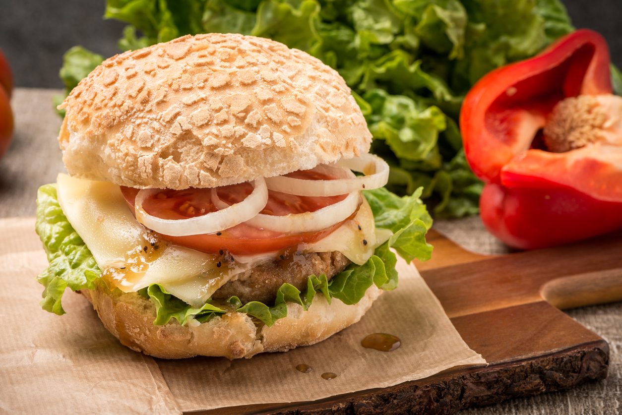 Close-up side view of the burger on brown paper