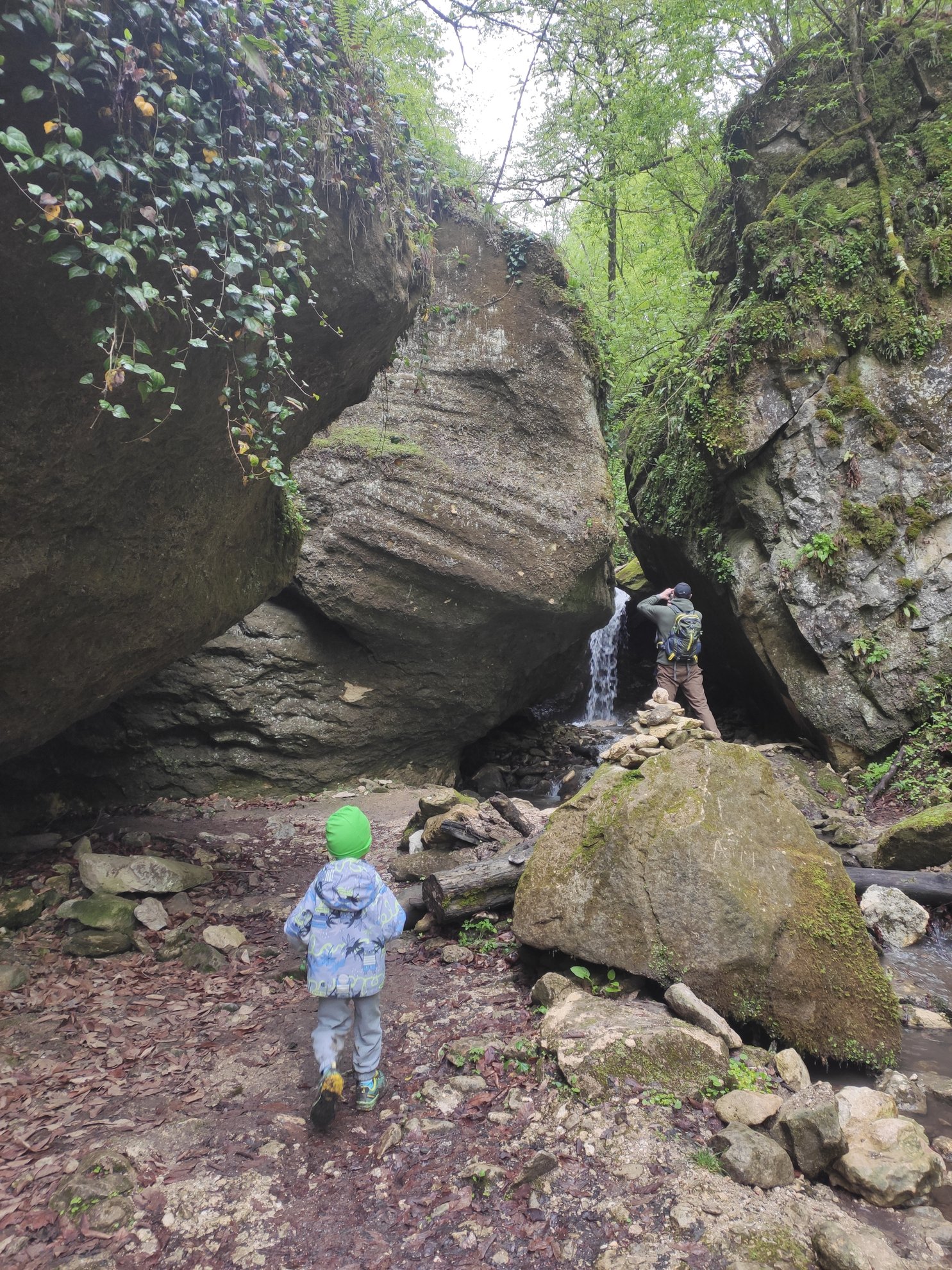 small waterfall between large boulders