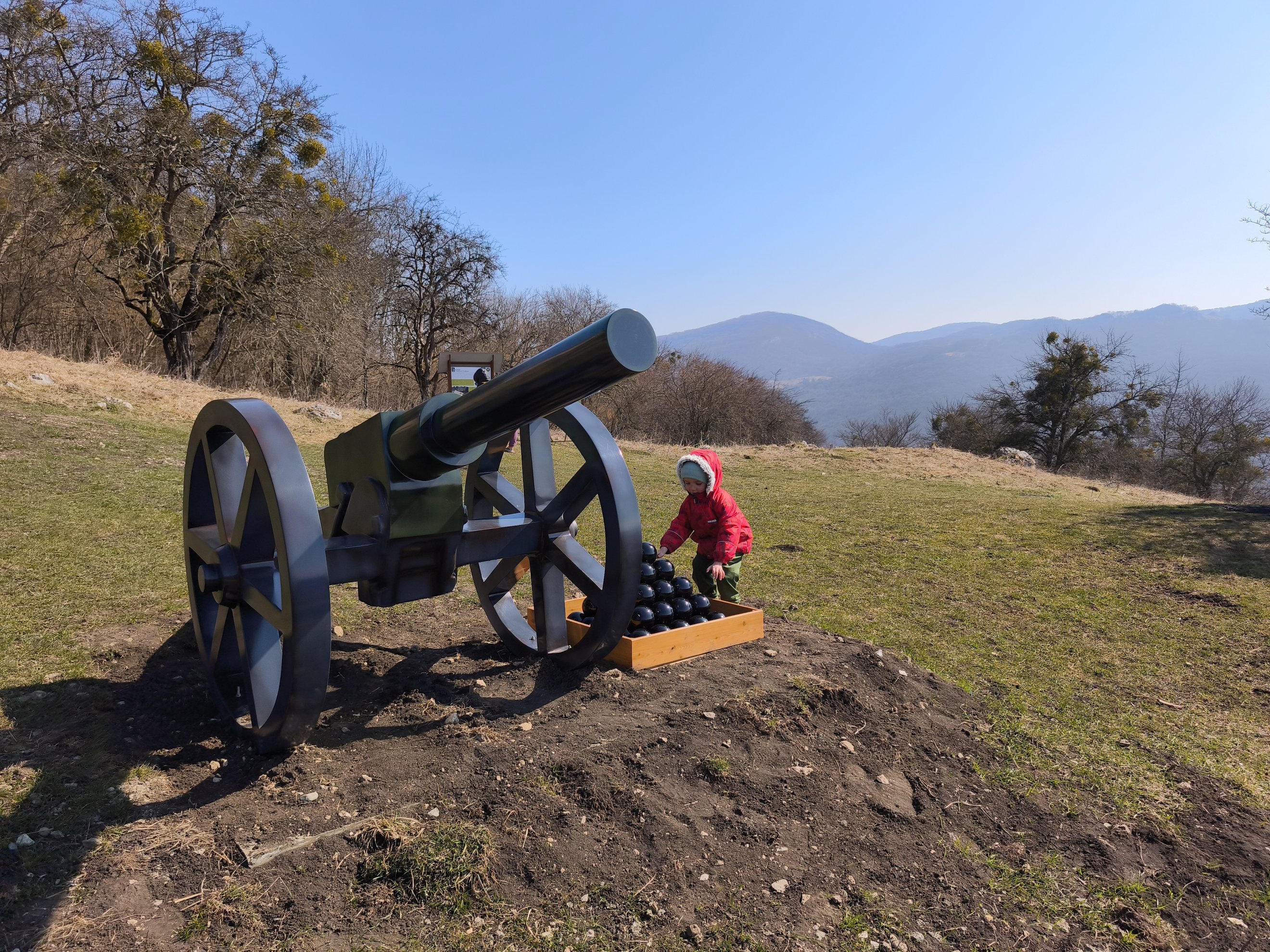 old cannon with cannonballs in a wooden crate