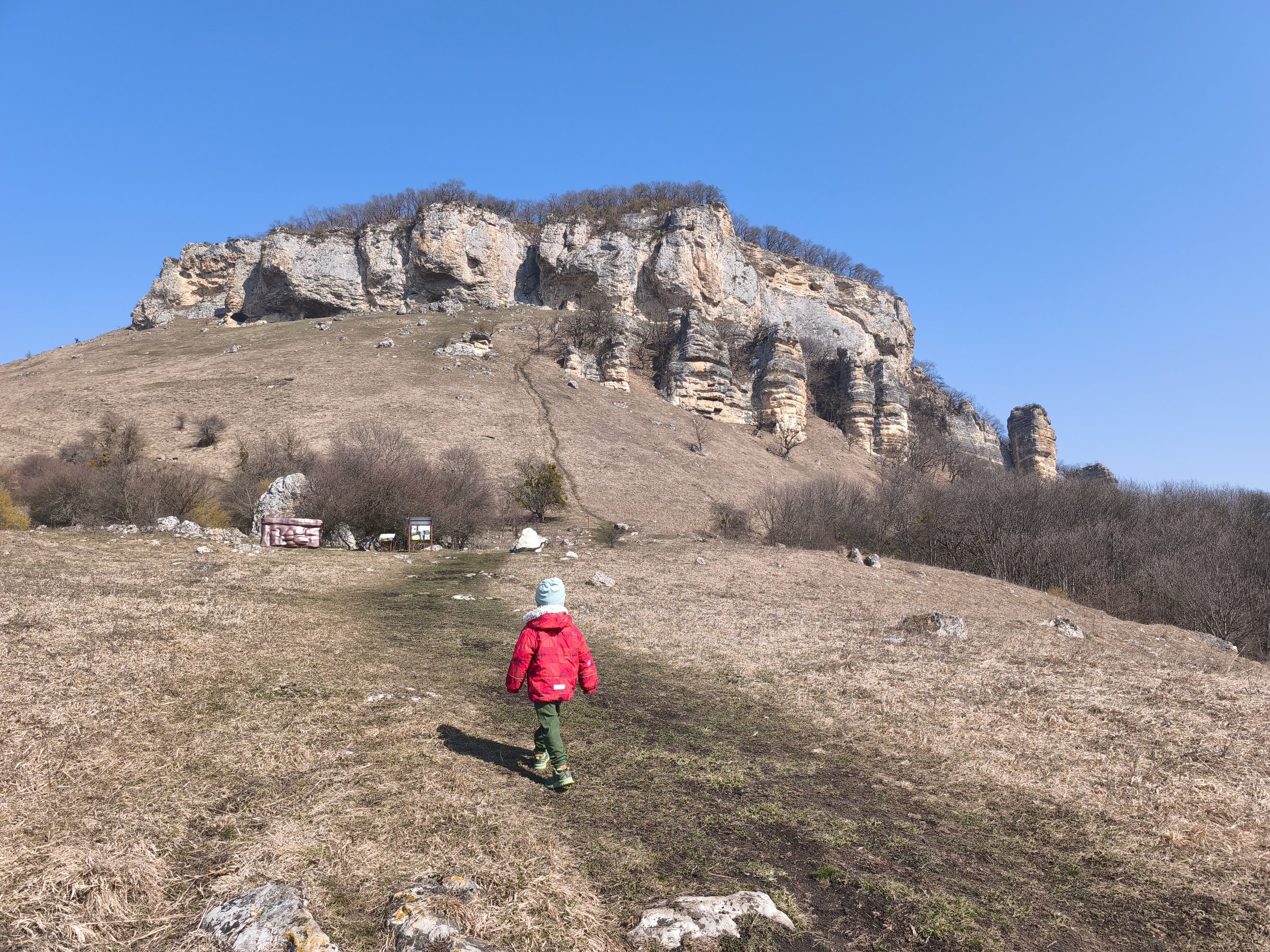 wide shot of the cliff face and hiking slope