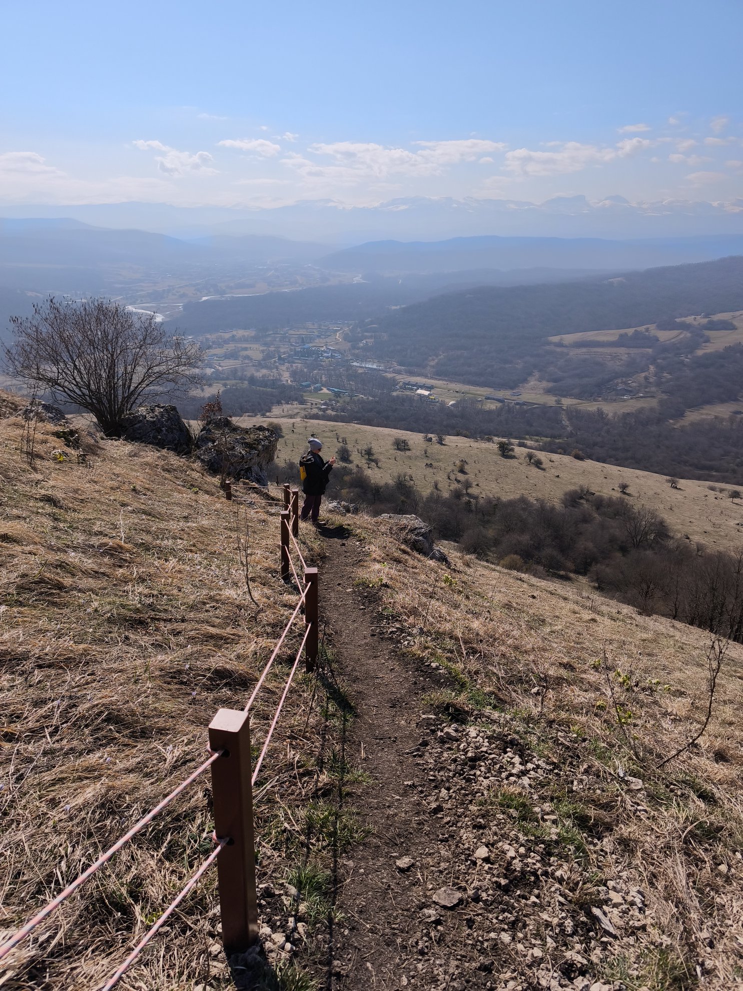 hiking path with rope railing overlooking a valley
