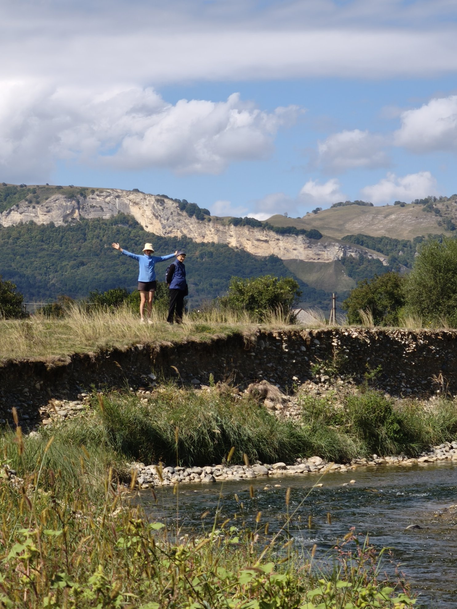 river bank with hills in the background