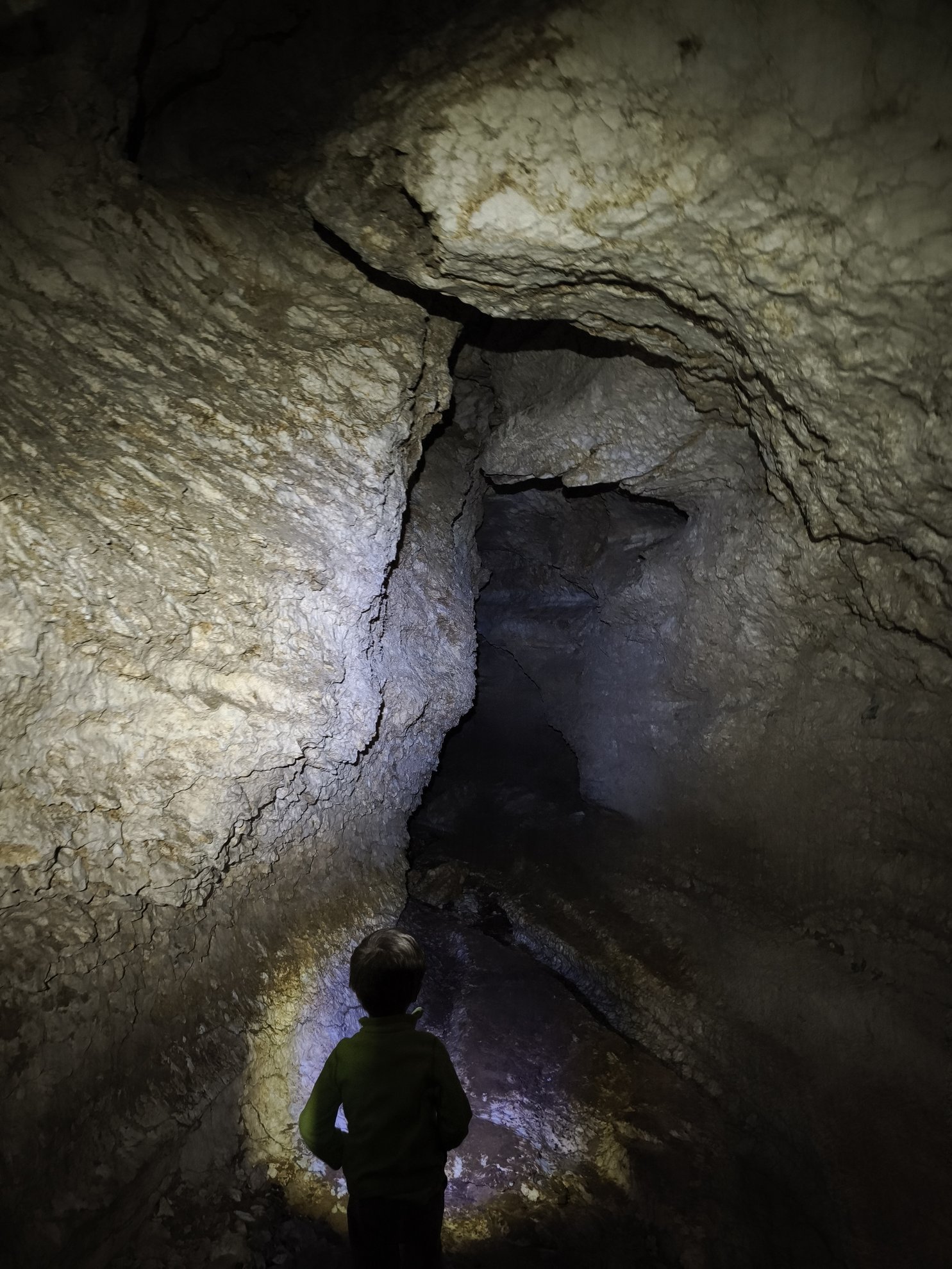 view of a narrow cave passage with rocky walls