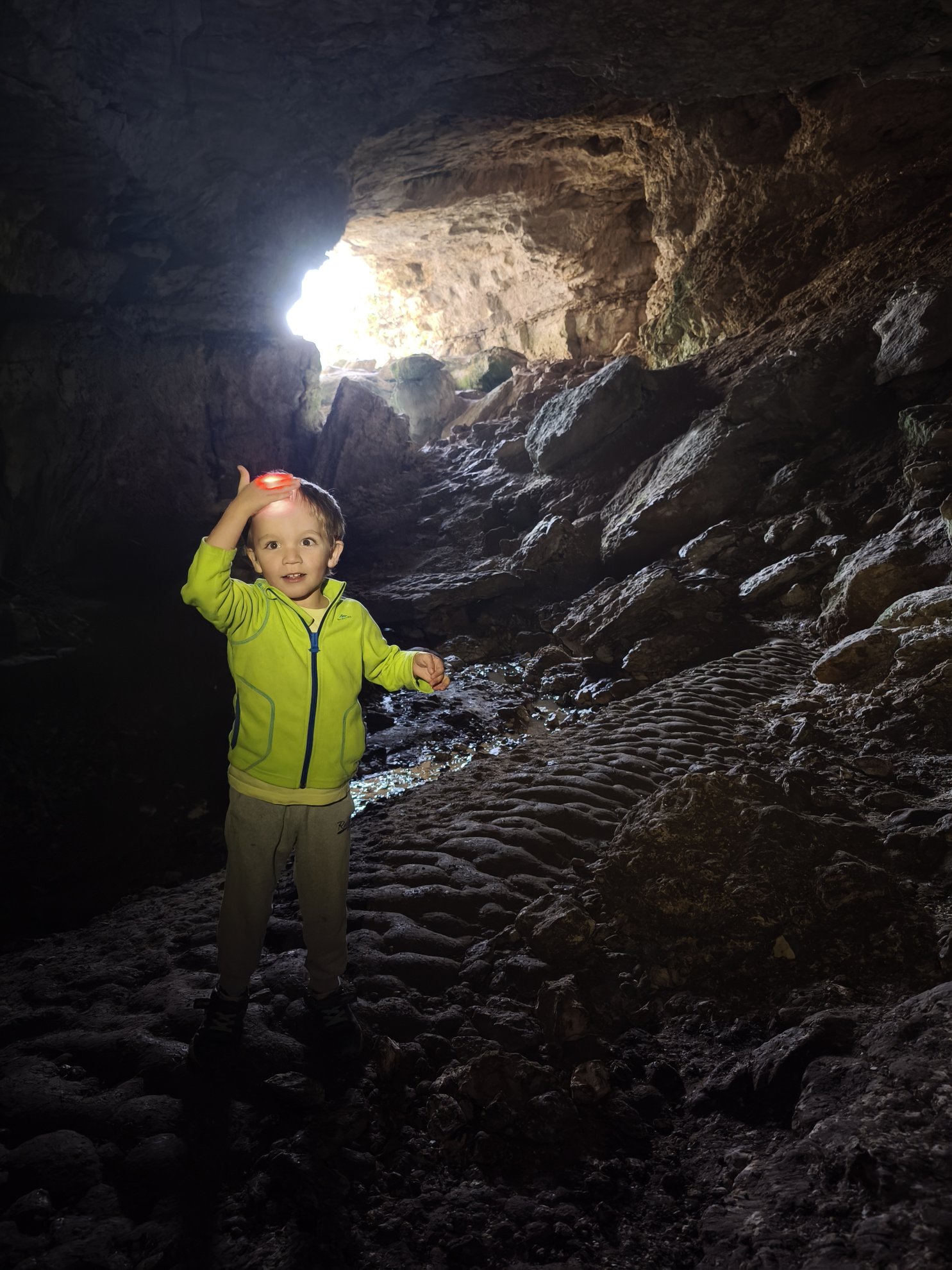interior view showing rocky floor and light from cave opening