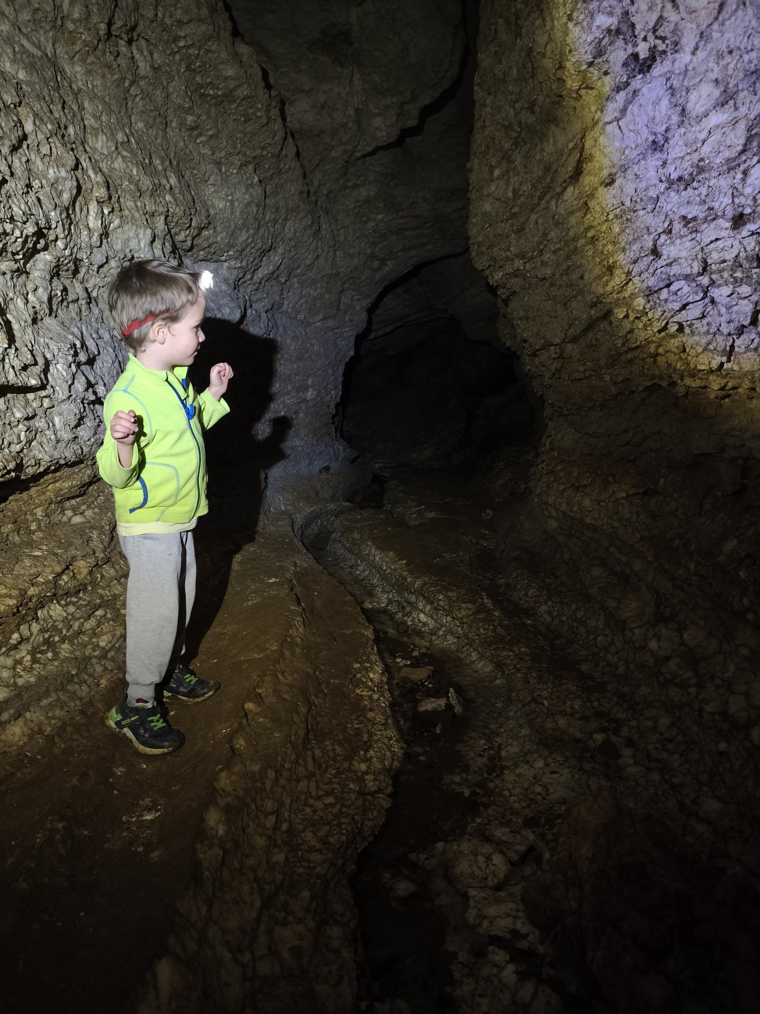 rocky interior passage with a flashlight beam