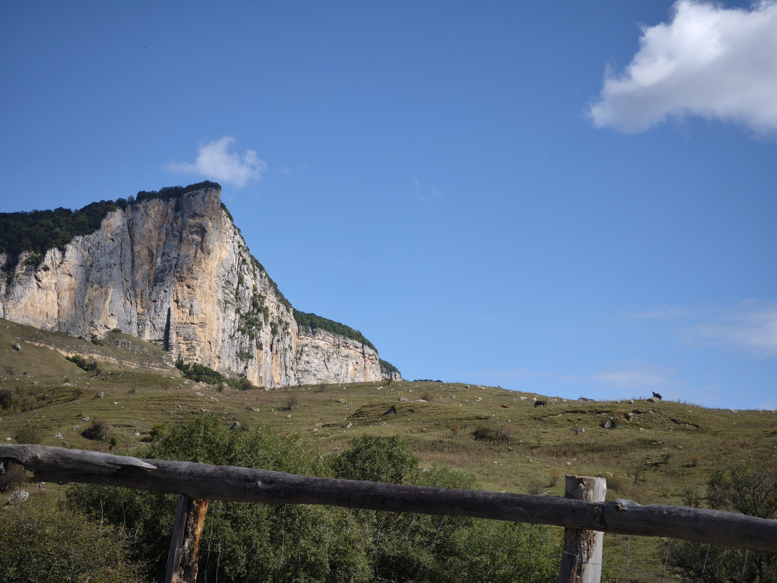 Low angle view of the cliff face and grassy slope