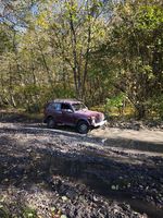 off-road vehicle on a muddy road with puddles